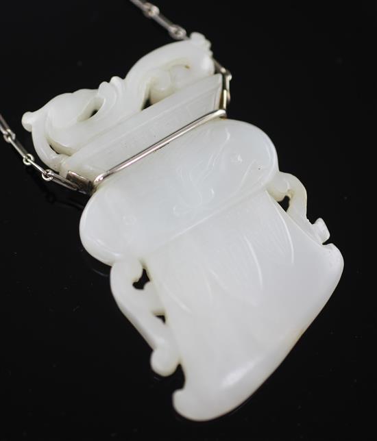 A Chinese archaistic white jade pendant, 19th / 20th century, (26cm drop), jade 6.7cm